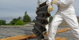 asbestos roof removal by people in white suits