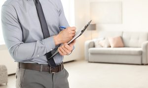 Property Manager holding clipboard inside loungeroom